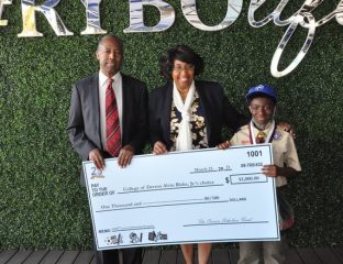 Derron Blake Jr., right, poses with Dr. Ben and Candy Carson and his $1,000 scholarship check.