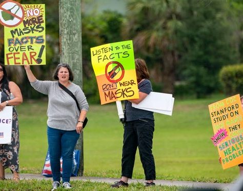 Anti-mask demonstrators stand along Forest Hill Blvd. outside the Palm Beach County School District offices during a school board meeting on April 21, 2021 in West Palm Beach, Florida. Greg Lovett, The Palm Beach Post