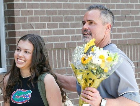 Niceville High School Principal Charlie Marello brings Niceville senior Laurel Wentworth to the school steps for a surprise celebration of her 2340 days of perfect school attendance. Michael Snyder, The Northwest Florida Daily News-USA TODAY NETWORK