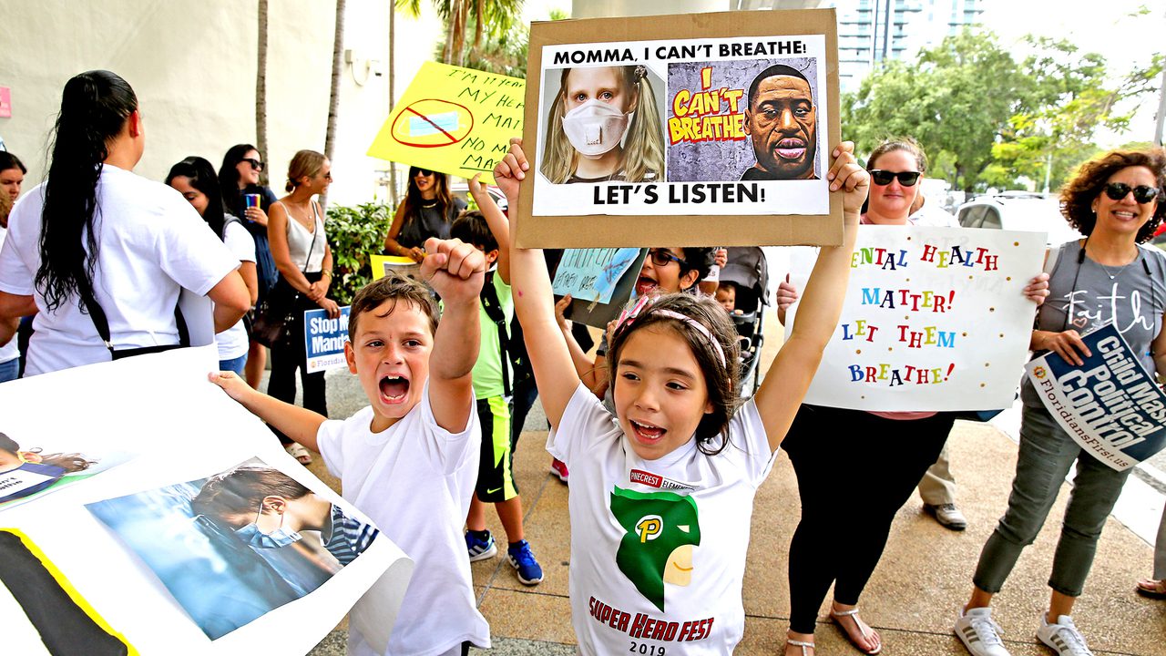 Ryan Pazze, 8, and Melanie Montes, 7, at an “Un-mask Our Kids” rally at the School Board administration building on May 19, 2021. Twenty-one speakers signed up to speak about masks during public comment. Many are against masks in schools. CHARLES TRAINOR JR CTRAINOR@MIAMIHERALD.COM