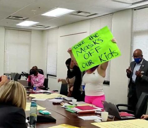 An anti-mask protester was escorted out of a Hillsborough County School Board retreat on May 4.