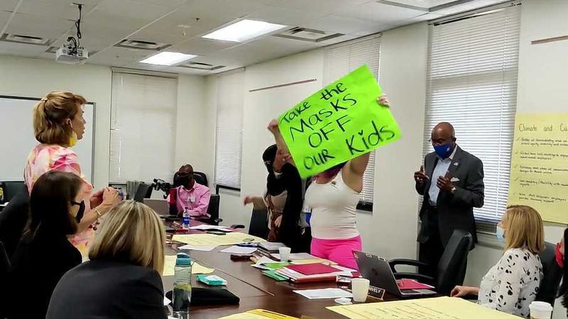 An anti-mask protester was escorted out of a Hillsborough County School Board retreat on May 4.