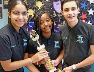 Jocelyn Hernandez, Gabriella Vega and Maurits Acosta hold one of the awards they won for an environmental project, on June 9, 2021. They are Miami Lakes Middle School students who proposed flood prevention legislation to the town council after Tropical Storm Eta flooded parts of the west Miami-Dade town, including their school auditorium
